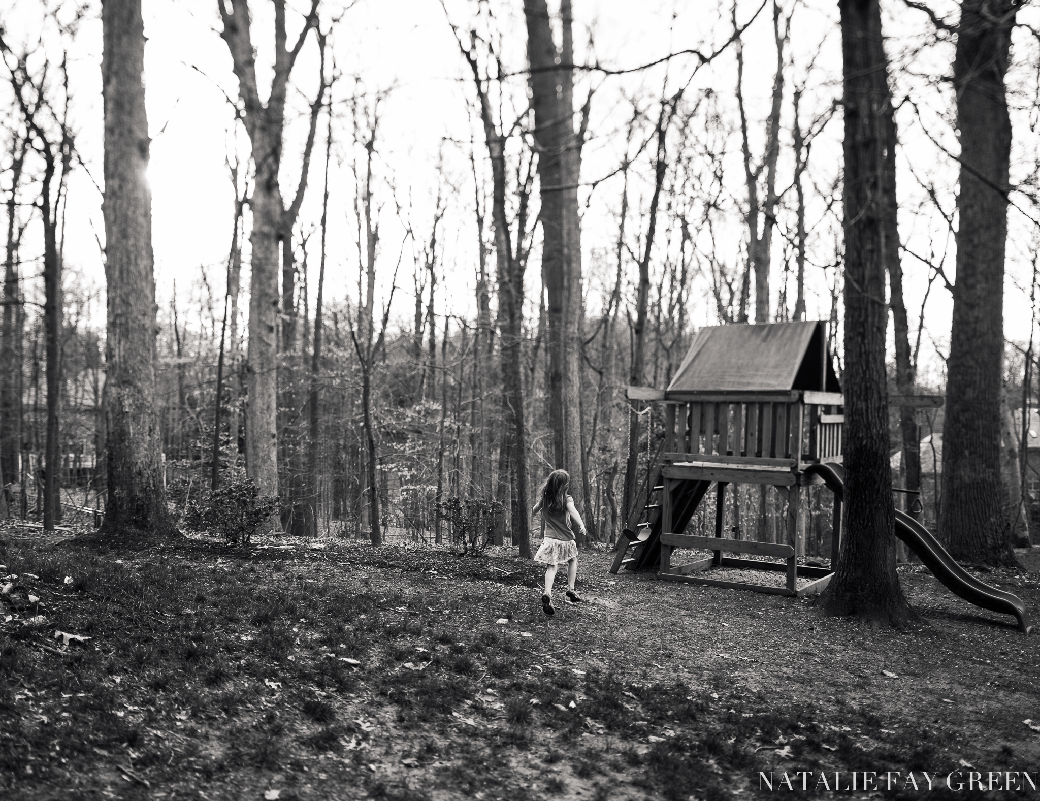 Girl running towards swings