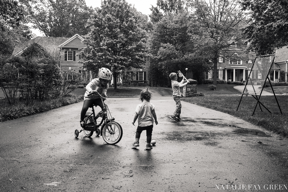 children playing in the driveway after rain | lacrosse | riding a bicycle with training wheels