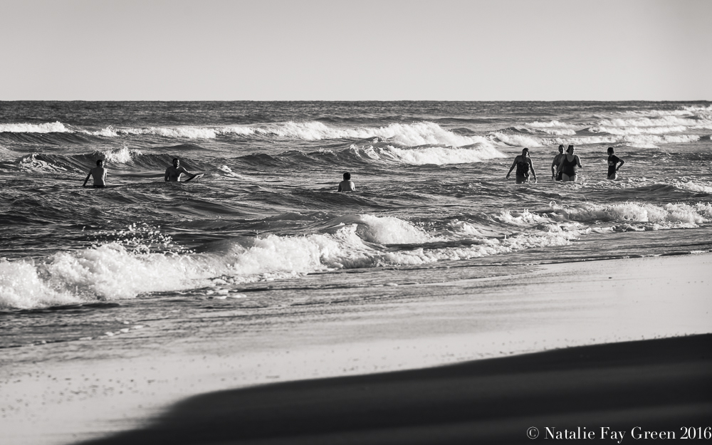 Surfers and Swimmers on the beach in Corolla North Carolina