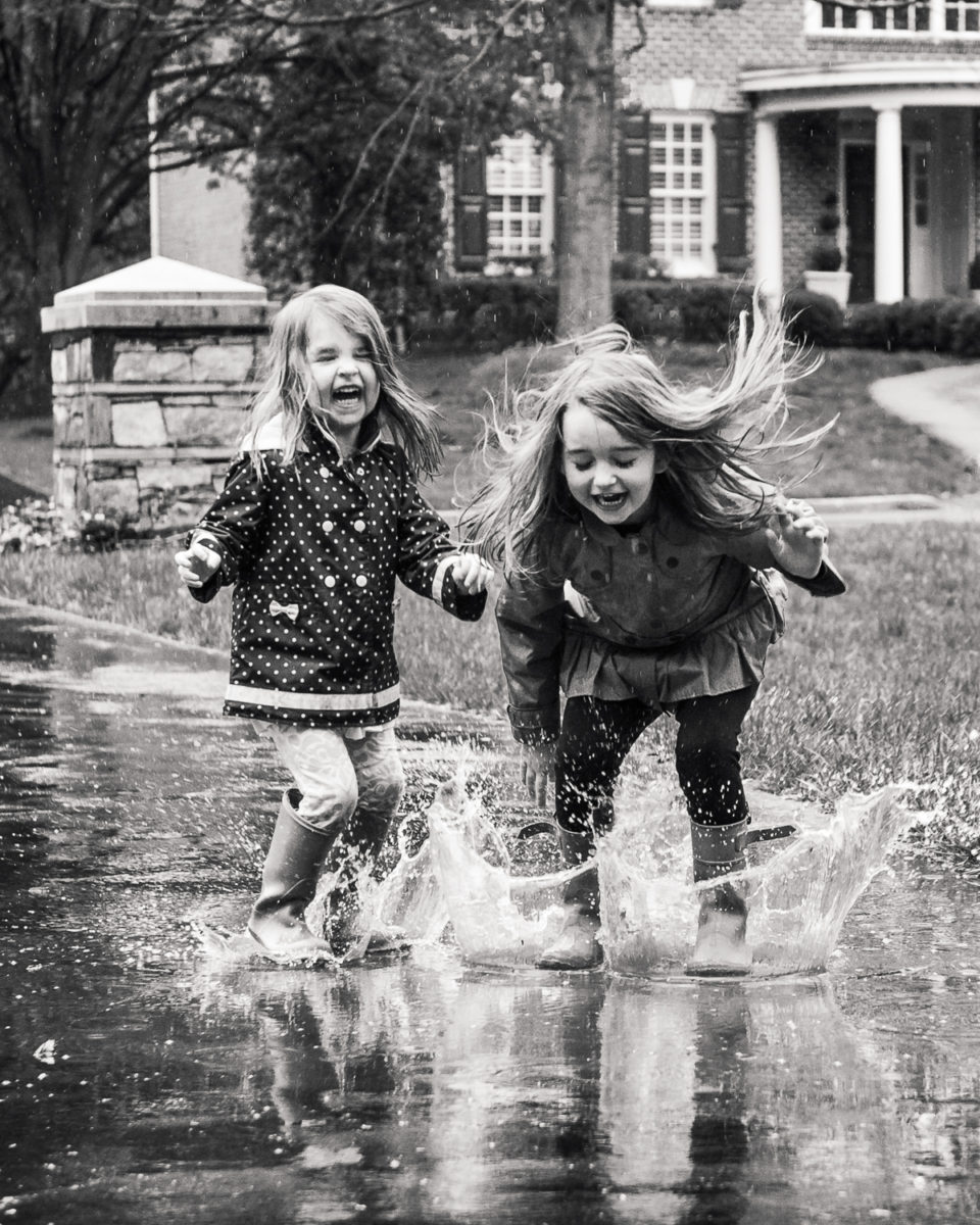 girls-driveway-puddle-jumping