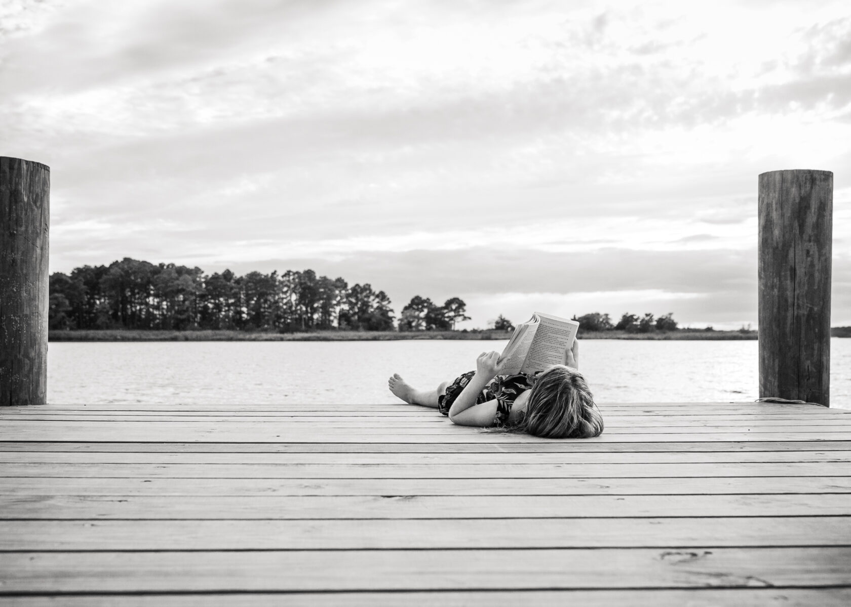 girl reading on dock