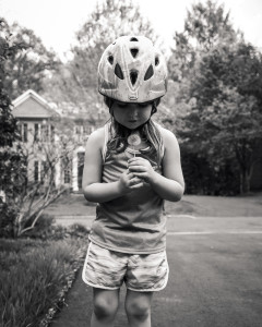 Little girl holding a dandelion weed