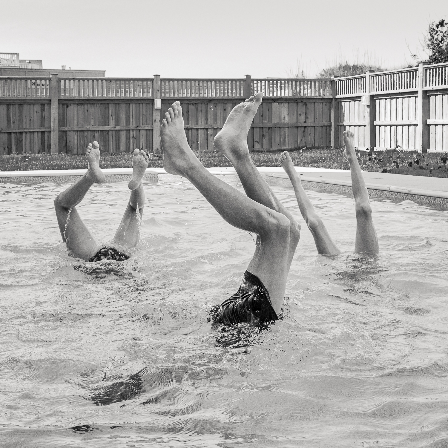 children doing handstands in a pool