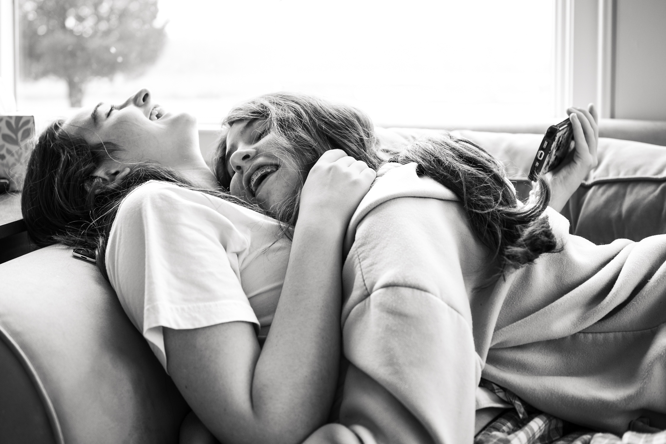 growinghumans-6 sisters laughing and hugging